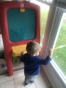 Toddler Painting With Water On Chalkboard
