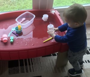 Toddler Playing In Water Table
